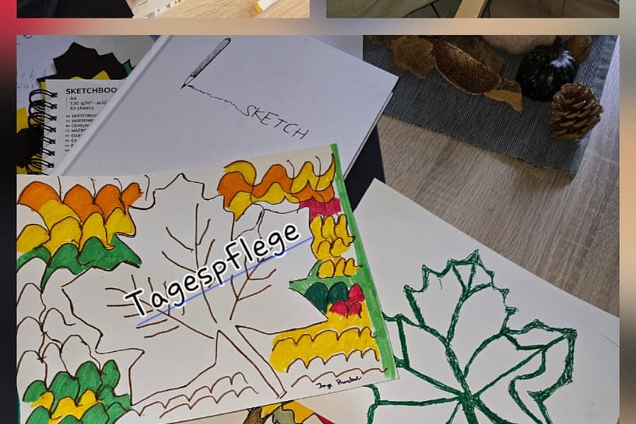Kreatives Malen mit bunten Blättern und Zeichnungen in einer Gruppe, zeigt kunstvolle Ergebnisse.